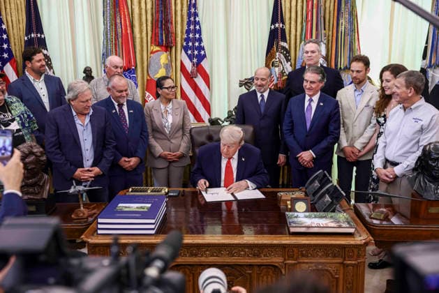 President Donald Trump signs documents restoring commercial fishing access to areas of the Pacific during a ceremony in the Oval Office of the White House in Washington DC on Thursday, June 11, 2026.  WAX20260611816 JIMxLOxSCALZO