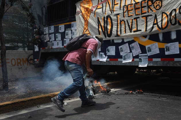 Demonstrators clash with police during the World Cup opener in Mexico City MEXICO CITY, MEXICO - JUNE 11: A demonstrator takes part in a protest against the World Cup, in Mexico City, Mexico on June 11, 2026. Thousands of demonstrators marched toward Banorte Stadium to protest against the World Cup, while some clashed with riot police outside the stadium where the World Cup opener was taking place. Daniel Cardenas Anadolu Mexico City Mexico. Editorial use only. Please get in touch for any other usage.  Copyright: x2026xAnadoluxDanielxCardenasx