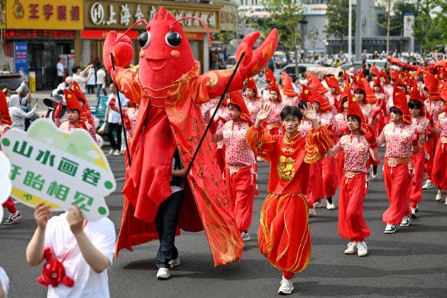 XUYI, CHINA - JUNE 12: People participate in a parade during the 26th International Crayfish Festival on June 12, 2026 in Xuyi County, Huai an City, Jiangsu Province of China. Chinese food enthusiasts are all set for a seasonal culinary delight, as Xuyi, a county in east China s Jiangsu Province known as the crayfish capital of China, inaugurates its annual crayfish festival.  Copyright: xVCGx 111647743466