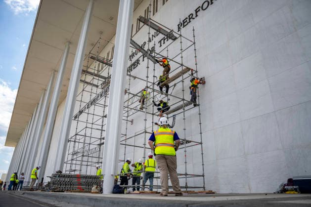 Construction workers build a scaffolding near the sign for the Donald J. Trump and The John F. Kennedy Memorial Center for the Performing Arts in Washington, DC on Friday, June 12, 2026. The Kennedy Center board voted to seek an emergency appeal to block a court order requiring the removal of President Trump s name from the Kennedy Center, but a judge denied their request.  WAP20260612412 BONNIExCASH