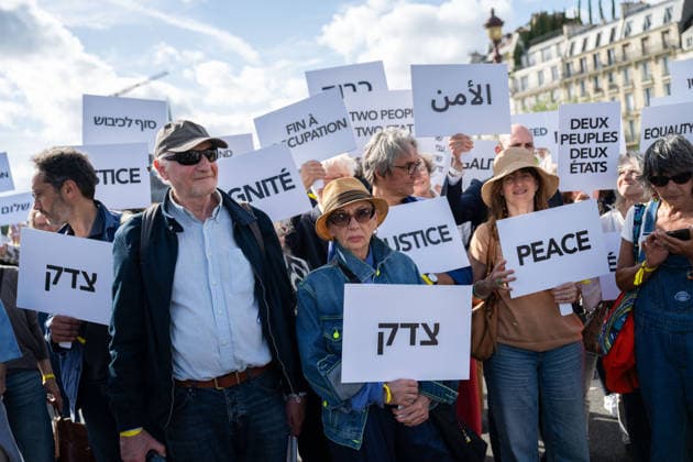 Press conference during the Paris Call for the Two-State Solution - Paris Participants of the Paris Call for the Two-State Solution with Israeli and Palestinian civil society groups carry placards on the Pont de La Tournelle birdge with the Notre-Dame de Paris Cathedral in the background in Paris, France on June 12, 2026. France is hosting this international meeting, attended by ministers from Brazil, Canada, the United Arab Emirates and Turkey, as well as the EU s High Representative for Foreign Affairs, following its recognition of the State of Palestine in 2025. French Foreign Minister reiterated Paris support for the two-state solution, stating that this year could be decisive at the close of the conference. Photo by Gregoire Campion  Copyright: xCampionexGregoire Pool ABACAx