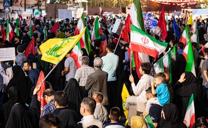 Iranians carries and National flag and Hezbollah, the Lebanese group, is a key ally of Iran flag during a rally , as crowds wave flags in support of the government s negotiations to end the war with the United States. Anti?U.S. and anti?Israel chants echoed through Enghelab Square in Tehran late Friday, June 12, 2026.  IRN2026061221 BehnamxTofighi