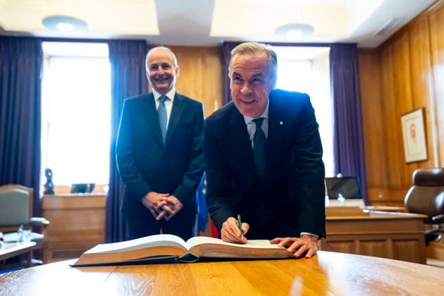 June 13, 2026, Dublin, Ireland: Prime Minister Mark Carney signs the Guest Book as Micheal Martin, Ireland s head of government looks on, at the Government Buildings in Dublin, on Saturday, June 13, 2026. Dublin Ireland  - ZUMAc35_ 20260613_zaf_c35_018 Copyright: xChristopherxKatsarovx