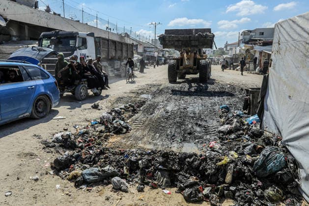 Teams affiliated with UNRWA carry out cleaning operations in Khan Yunis KHAN YUNIS, GAZA, PALESTINE - JUNE 13: Teams from the United Nations Relief and Works Agency for Palestine Refugees in the Near East (UNRWA) use heavy machinery to remove garbage piled up on the streets of Khan Yunis, Gaza, Palestine, on June 13, 2026. Waste has been accumulating on streets and near residential areas due to severe damage to infrastructure caused by attacks, insufficient municipal vehicles. Abed Rahim Khatib Anadolu Khan Yunis Gaza. Editorial use only. Please get in touch for any other usage.  Copyright: x2026xAnadoluxAbedxRahimxKhatibx