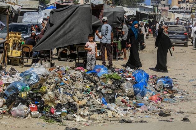 Teams affiliated with UNRWA carry out cleaning operations in Khan Yunis KHAN YUNIS, GAZA, PALESTINE - JUNE 13: A view of accumulated garbage as teams from the United Nations Relief and Works Agency for Palestine Refugees in the Near East (UNRWA) use heavy machinery to remove garbage piled up on the streets of Khan Yunis, Gaza, Palestine, on June 13, 2026. Waste has been accumulating on streets and near residential areas due to severe damage to infrastructure caused by attacks, insufficient municipal vehicles. Abed Rahim Khatib Anadolu Khan Yunis Gaza. Editorial use only. Please get in touch for any other usage.  Copyright: x2026xAnadoluxAbedxRahimxKhatibx