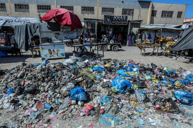 Teams affiliated with UNRWA carry out cleaning operations in Khan Yunis KHAN YUNIS, GAZA, PALESTINE - JUNE 13: A view of accumulated garbage as teams from the United Nations Relief and Works Agency for Palestine Refugees in the Near East (UNRWA) use heavy machinery to remove garbage piled up on the streets of Khan Yunis, Gaza, Palestine, on June 13, 2026. Waste has been accumulating on streets and near residential areas due to severe damage to infrastructure caused by attacks, insufficient municipal vehicles. Abed Rahim Khatib Anadolu Khan Yunis Gaza. Editorial use only. Please get in touch for any other usage.  Copyright: x2026xAnadoluxAbedxRahimxKhatibx