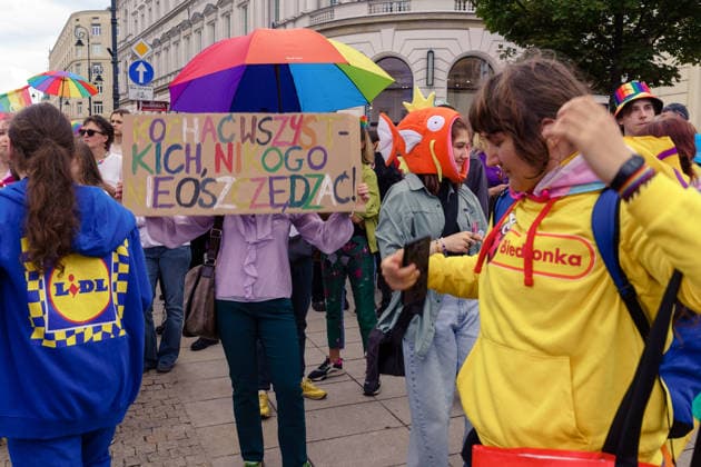 The 25th Pride Warsaw. Parade participants dressed in Lid and Biedronka discount grocery store costiumes, with a benner between them reading: love everyone, dont t save no one. Warsaw Poland Copyright: xMikolajxJaneczekx