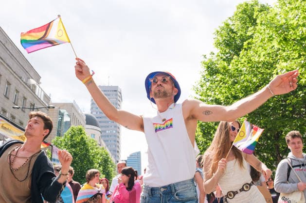 June 13, 2026, Warsaw, Masovian Voivodeship, Poland: A person wearing a proud shirt dances and waves a small rainbow pride flag during the 25th annual Warsaw LGBTQ+ Pride Parade, known in Polish as the Equality Parade. LGBTQ+ people in Poland do not have the right to same-sex civil partnerships, marriage, and child adoption, while also facing homophobia and queerphobia from a largely conservative society. Therefore, the parade is organized primarily as a march for equal rights. Warsaw Poland - ZUMAk204 20260613_zip_k204_008 Copyright: xRomanxKozielx