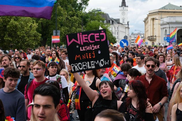 June 13, 2026, Warsaw, Masovian Voivodeship, Poland: A person holds up a sign that reads more lesbians, less problems as thousands of people march during the 25th annual Warsaw LGBTQ+ Pride Parade, known in Polish as the Equality Parade. LGBTQ+ people in Poland do not have the right to same-sex civil partnerships, marriage, and child adoption, while also facing homophobia and queerphobia from a largely conservative society. Therefore, the parade is organized primarily as a march for equal rights. Warsaw Poland  - ZUMAk204 20260613_zip_k204_023 Copyright: xRomanxKozielx