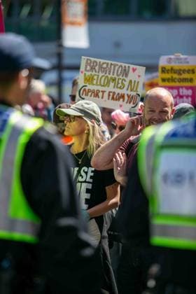 June 13, 2026, Brighton, UK: Brighton, UK. 13 June 2026. Anti-immigration protesters and counter protesters gather in the city centre of Brighton. The South East Patriots held a march through the centre of Brighton, with about twenty groups under the banner of Carnival Against Fascism organising a counter protest. Police officers kept the two groups apart as tensions were running high. South East Patriots claimed the protest was to demand stronger border control, enforcement of immigration laws, and the deportation of illegal immigrants, with the counter protest groups expressing their resistance against the far right as well as to any form of fascism and racism Brighton UK - ZUMAd99_ 20260613_zap_d99_040 Copyright: xMattxDuckettx
