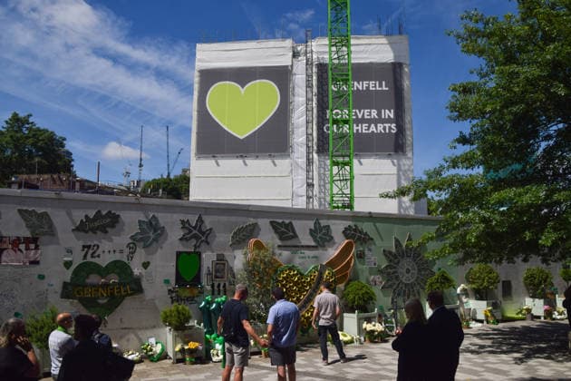June 14, 2026, London, England, United Kingdom: People gather at the memorial wall next to the remains of Grenfell Tower, which is undergoing demolition, on the ninth anniversary of the disaster. 72 people died when a fire broke out in the block of flats in North Kensington in 2017. London United Kingdom  - ZUMAv130 20260614_zip_v130_007 Copyright: xVukxValcicx