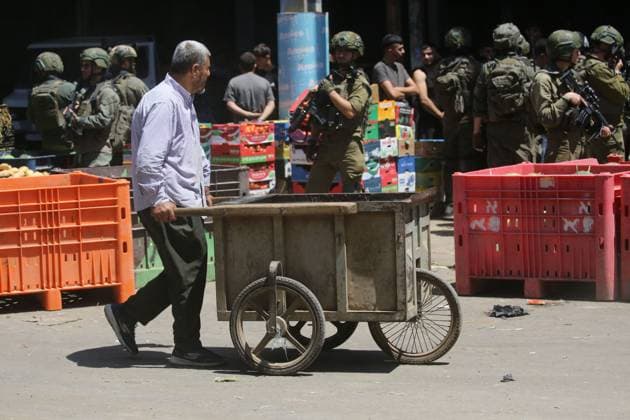 Israeli Forces Conduct Raid in Central Market Area of Nablus NABLUS, WEST BANK JUNE 14, 2026: Israeli soldiers are seen in the central vegetable market area during a military raid in the city of Nablus, in the occupied West Bank. NABLUS Palestine, State of Copyright: x xJNAxEDITORx xJNAxPressx
