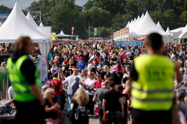 Stewards guarding an emergency exit in the background Guests in colorful party costumes at the festival Inselfieber in the outdoor area of the Rudolf Weber Arena in Oberhausen on Oberhausen, 13 06 2026 NRW Germany Copyright: xChristophxHardtx