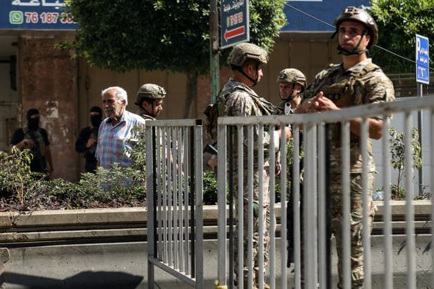 June 14, 2026, Beirut, Beirut, Lebanon: A Lebanese resident stands near army soldiers securing the site where a building was targeted by Israeli strike in Beirut southern suburb, a bastion of pro-Iranian Hezbollah. Three people were killed in the attack, according to Lebanon s state media. The Israel Defense Forces (IDF) said it targeted a command center used by Hezbollah after the Iran-backed armed group launched aerial targets toward Israel Beirut Lebanon  - ZUMAn313 20260614_zip_n313_015 Copyright: xMarwanxNaamanix