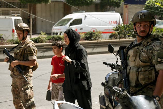 June 14, 2026, Beirut, Beirut, Lebanon: A Lebanese resident leaves with her son the area where a building was targeted by Israeli strike in Beirut southern suburb, a bastion of pro-Iranian Hezbollah. Three people were killed in the attack, according to Lebanon s state media. The Israel Defense Forces (IDF) said it targeted a command center used by Hezbollah after the Iran-backed armed group launched aerial targets toward Israel Beirut Lebanon  - ZUMAn313 20260614_zip_n313_005 Copyright: xMarwanxNaamanix