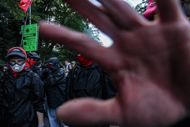 June 14, 2026, Geneva, Switzerland, European Union: A protester covers the camera as protesters run away from tear gas fired by police during a demonstration in Geneva ahead of the G7 summit. Geneva European Union  - ZUMAo116 20260614_znp_o116_014 Copyright: xBiancaxOterox