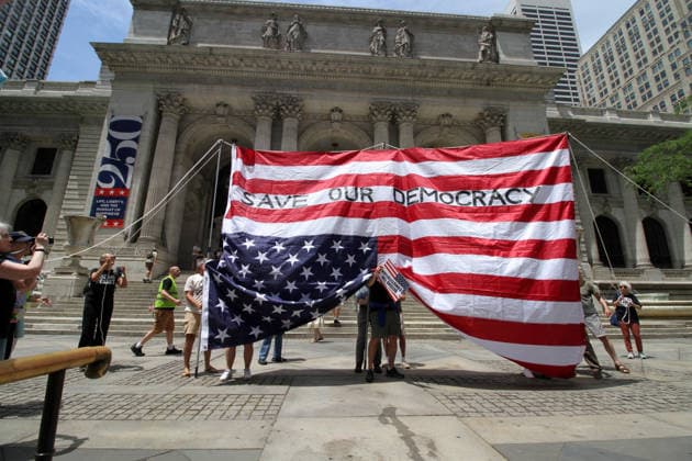 June 14, 2026, Manhattan, New York, USA: New York, New York June 14,.2026... The group Rise and Resist today protested President Trump by flying a 12 x 18 foot Ã¢â‚¬oedistressedÃ¢â‚¬Â American flag in front of a place free of Trump & Republicans, the steps of the New York Public Library. Manhattan USA  - ZUMAct2_ 20260614_faf_ct2_029 Copyright: xBrucexCotlerx