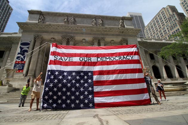 June 14, 2026, Manhattan, New York, USA: New York, New York June 14,.2026... The group Rise and Resist today protested President Trump by flying a 12 x 18 foot Ã¢â‚¬oedistressedÃ¢â‚¬Â American flag in front of a place free of Trump & Republicans, the steps of the New York Public Library. Manhattan USA  - ZUMAct2_ 20260614_faf_ct2_033 Copyright: xBrucexCotlerx