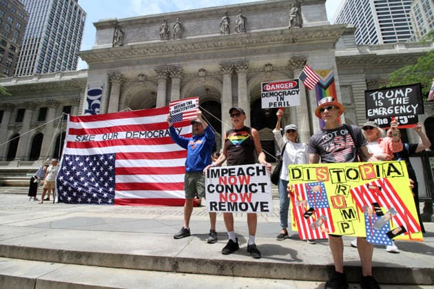 June 14, 2026, Manhattan, New York, USA: New York, New York June 14,.2026... The group Rise and Resist today protested President Trump by flying a 12 x 18 foot Ã¢â‚¬oedistressedÃ¢â‚¬Â American flag in front of a place free of Trump & Republicans, the steps of the New York Public Library. Manhattan USA  - ZUMAct2_ 20260614_faf_ct2_034 Copyright: xBrucexCotlerx
