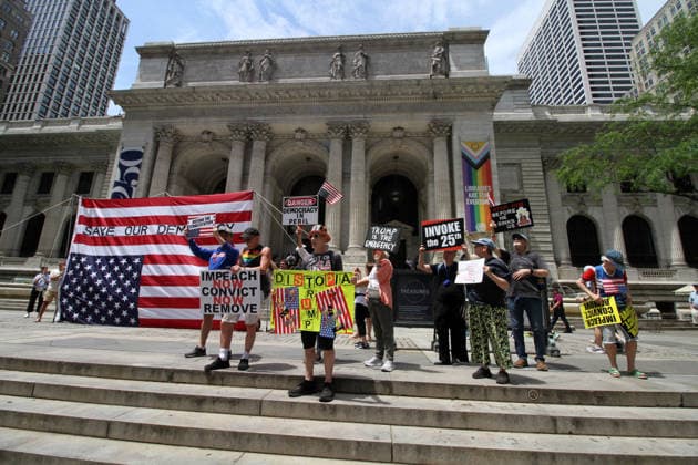 June 14, 2026, Manhattan, New York, USA: New York, New York June 14,.2026... The group Rise and Resist today protested President Trump by flying a 12 x 18 foot Ã¢â‚¬oedistressedÃ¢â‚¬Â American flag in front of a place free of Trump & Republicans, the steps of the New York Public Library. Manhattan USA  - ZUMAct2_ 20260614_faf_ct2_051 Copyright: xBrucexCotlerx