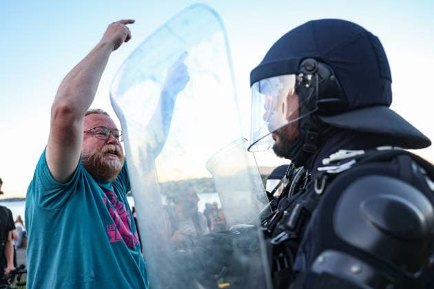 June 14, 2026, Geneva, Switzerland, European Union: A protester speaks with police officers behind riot shields during demonstrations in Geneva ahead of the G7 summit, which begins tomorrow in Evian-les-Bains, as tensions rise between protesters and security forces. Geneva European Union - ZUMAo116 20260614_znp_o116_030 Copyright: xBiancaxOterox