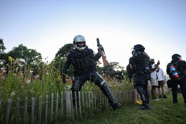 June 14, 2026, Geneva, Switzerland, European Union: A police officer holding a tear gas gun moves through a flower bed to form a cordon during demonstrations in Geneva ahead of the G7 summit, which begins tomorrow in Evian-les-Bains. Geneva European Union - ZUMAo116 20260614_znp_o116_038 Copyright: xBiancaxOterox