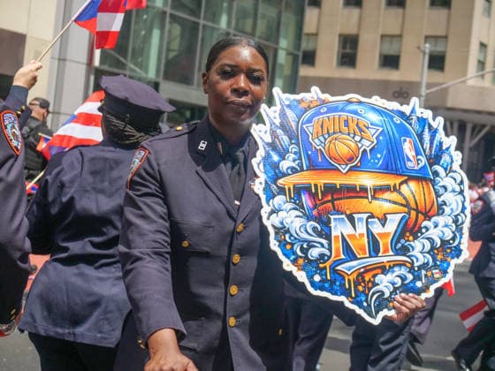 June 14, 2026, New York, New York, USA: NYC Corrections Officer showing her NY Knicks pride at the 69th annual Puerto Rican Day Parade which made its way up Fifth Avenue to a sea of red white and blue celebrating the expansive cultural legacy and global footprint of .Puerto Rico. Salsa music, floats, dance and Puerto Rican pride filled the air as thousands marched and.watched from the sidelines. New York USA  - ZUMAh156 20260614_znp_h156_007 Copyright: xMiloxHessx