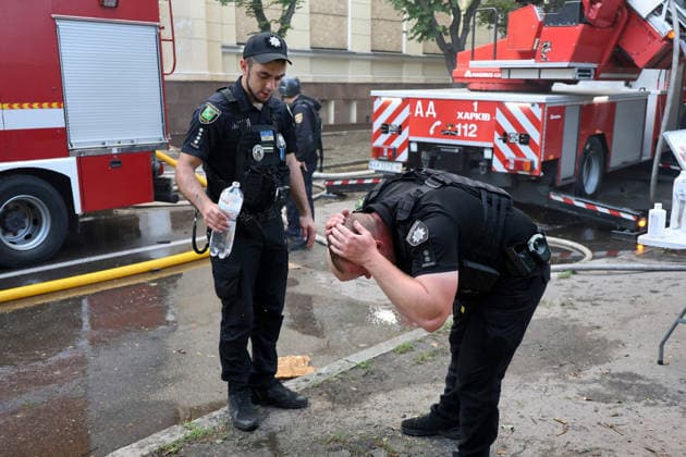 A police officer helps his colleague cool his head with water during a response effort to a fire at the Kharkiv Art Museum, damaged by a Russian drone strike, Kharkiv, Ukraine, June 14, 2026. The Russian army attacked the northeastern city with drones, injuring five people, including a one-month-old baby. On the afternoon of June 14, Russians struck two districts of Kharkiv with drones. (Photo by Viacheslav Madiievskyi Ukrinform) Russians strike Kharkiv Art Museum with drone  Copyright: xViacheslavxMadiievskyix
