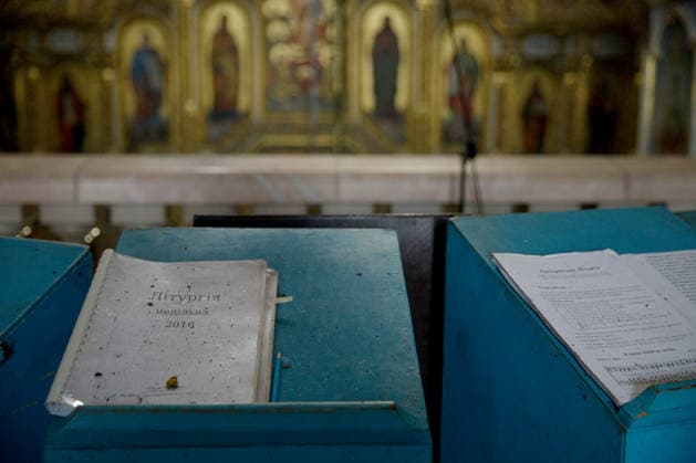 Liturgical books, covered with dust, lie on analogions in the Dormition Cathedral at the Kyiv Pechersk Lavra, where the roof caught fire during a massive Russian combined attack, Kyiv, Ukraine, June 15, 2026. The Russian army launched a large-scale assault on the Ukrainian capital with missiles and strike drones, killing four people and injuring 28, including children and a pregnant woman. At least 140,000 consumers were left without electricity due to damage to power grids. Residential buildings, the Kyiv Pechersk Lavra, the Mystetskyi Arsenal Museum Complex, the Dovzhenko Film Studio, and the building of the High Anti-Corruption Court sustained damage. (Photo by Marianna Kotyk Ukrinform) Massive Russian attack damages Kyiv Pechersk Lavra  Copyright: xMariannaxKotykx