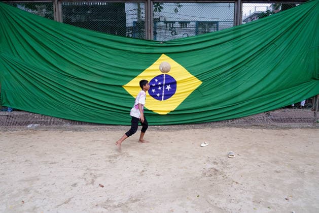 June 15, 2026, Dhaka, Dhaka, Bangladesh: Dhaka, Bangladesh Ã¢â‚¬ June 15, 2026 As FIFA World Cup fever sweeps across the globe, Bangladesh has also been caught up in the excitement. Football fans throughout the country are enthusiastically supporting their favorite teams, creating a festive atmosphere nationwide...Supporters are purchasing team jerseys, flags, and other memorabilia ahead of the tournament. Shops and street vendors are witnessing increased demand for World Cup-related merchandise, while roads, neighborhoods, and rooftops are decorated with colorful national flags representing competing nations...Children and teenagers have also joined the celebration, taking to streets and playgrounds with footballs in hand, inspired by t - ZUMAk185 20260615_zip_k185_058 Copyright: xRubelxKarmakerx