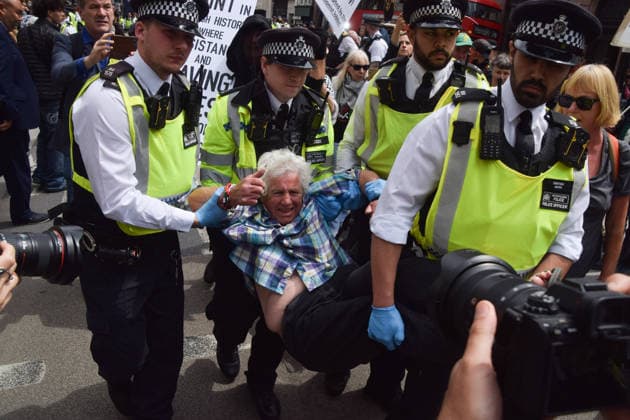 June 15, 2026, London, England, United Kingdom: Police officers arrest a protester outside the Royal Courts of Justice as the ban on the activist group Palestine Action is ruled as lawful by the Court of Appeal. Judges have overturned a previous ruling that the ban on the group was wrong. Protesters sat outside the court with placards stating Ã¢â‚¬ËœSaving lives is not terrorism, I support Palestine ActionÃ¢ London United Kingdom  - ZUMAv130 20260615_zip_v130_007 Copyright: xVukxValcicx