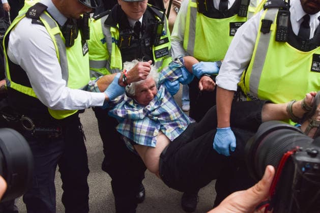 June 15, 2026, London, England, United Kingdom: Police officers arrest a protester outside the Royal Courts of Justice as the ban on the activist group Palestine Action is ruled as lawful by the Court of Appeal. Judges have overturned a previous ruling that the ban on the group was wrong. Protesters sat outside the court with placards stating Ã¢â‚¬ËœSaving lives is not terrorism, I support Palestine ActionÃ¢ London United Kingdom  - ZUMAv130 20260615_zip_v130_008 Copyright: xVukxValcicx