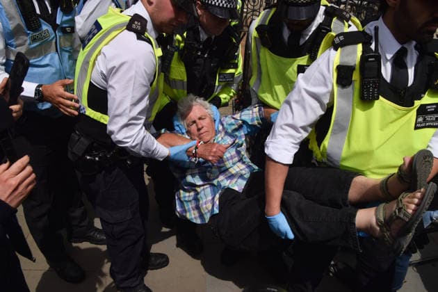 June 15, 2026, London, England, United Kingdom: Police officers arrest a protester outside the Royal Courts of Justice as the ban on the activist group Palestine Action is ruled as lawful by the Court of Appeal. Judges have overturned a previous ruling that the ban on the group was wrong. Protesters sat outside the court with placards stating Ã¢â‚¬ËœSaving lives is not terrorism, I support Palestine ActionÃ¢ London United Kingdom - ZUMAv130 20260615_zip_v130_004 Copyright: xVukxValcicx