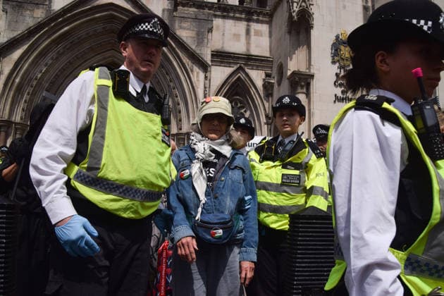 June 15, 2026, London, England, United Kingdom: Police officers arrest a protester outside the Royal Courts of Justice as the ban on the activist group Palestine Action is ruled as lawful by the Court of Appeal. Judges have overturned a previous ruling that the ban on the group was wrong. Protesters sat outside the court with placards stating Ã¢â‚¬ËœSaving lives is not terrorism, I support Palestine ActionÃ¢ London United Kingdom - ZUMAv130 20260615_zip_v130_010 Copyright: xVukxValcicx
