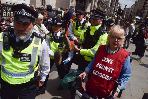 June 15, 2026, London, England, United Kingdom: Police officers arrest a protester outside the Royal Courts of Justice as the ban on the activist group Palestine Action is ruled as lawful by the Court of Appeal. Judges have overturned a previous ruling that the ban on the group was wrong. Protesters sat outside the court with placards stating Ã¢â‚¬ËœSaving lives is not terrorism, I support Palestine ActionÃ¢ London United Kingdom - ZUMAv130 20260615_zip_v130_012 Copyright: xVukxValcicx