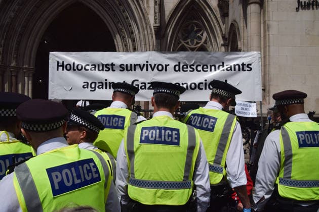 June 15, 2026, London, England, United Kingdom: Police officers arrest protesters sitting under a banner stating Holocaust survivor descendants against Gaza genocde outside the Royal Courts of Justice as the ban on the activist group Palestine Action is ruled as lawful by the Court of Appeal. Judges have overturned a previous ruling that the ban on the group was wrong. Protesters sat outside the court with placards stating Ã¢â‚¬ËœSaving lives is not terrorism, I support Palestine ActionÃ¢ London United Kingdom - ZUMAv130 20260615_zip_v130_013 Copyright: xVukxValcicx
