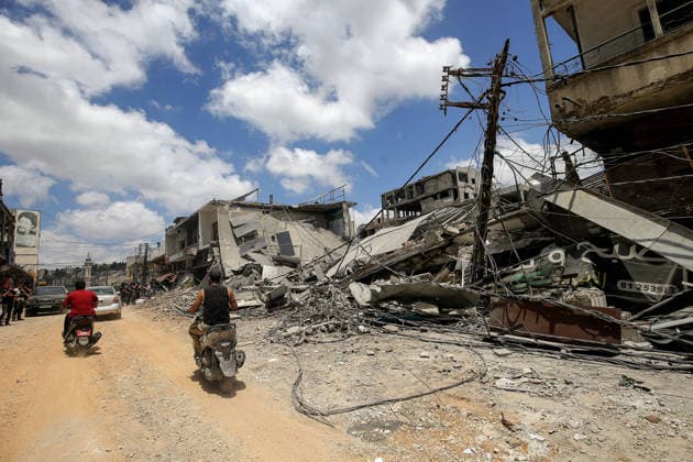 June 15, 2026, Nabatieh, Nabatieh, Lebanon: Lebanese drive their motorcycles devastated buildings in the southern Lebanese city of Nabatieh. Scores of families started to return to their villages following the announcement of an initial ceasefire agreement between the United States and Iran. Nabatieh Lebanon  - ZUMAn313 20260615_zip_n313_011 Copyright: xMarwanxNaamanix