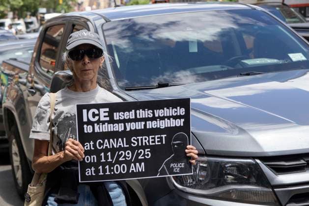 June 15, 2026, New York, New York, USA: An anti-ICE (Immigration Customs and Enforcement) demonstrator holds a sign reading ICE used this vehicle to kidnap your neighbor at CANAL STREET on 11 29 25 at 11 AM with an image of a masked agent wearing a vest that reads POLICE ICE, identifying a car parked on the street near the Department of Justice Immigration Courts at 201 Varick Street in Greenwich Village. Recently Border Czar T. Homan threatened to send a surge of immigration agents to New York City after Governor Hochul signed legislation barring state and local law enforcement from working with immigration in New York jails. New York USA - ZUMAr174 20260615_znp_r174_016 Copyright: xGinaxMxRandazzox