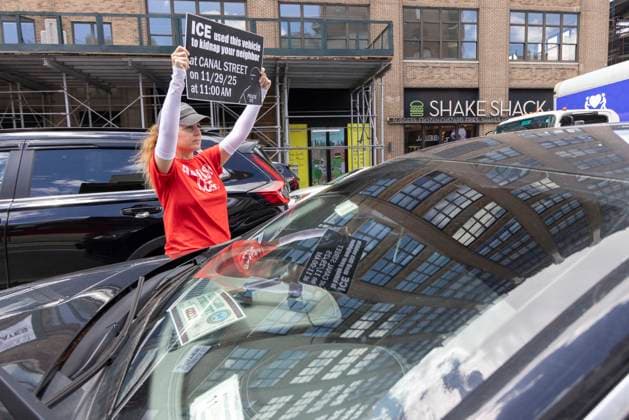 June 15, 2026, New York, New York, USA: An anti-ICE (Immigration Customs and Enforcement) demonstrator wears a shirt that reads ABOLISH ICE and holds a sign reading ICE used this vehicle to kidnap your neighbor at CANAL STREET on 11 29 25 at 11 AM with an image of a masked agent wearing a vest that reads POLICE ICE, identifying a car parked on the street near the Department of Justice Immigration Courts at 201 Varick Street in Greenwich Village. Recently Border Czar T. Homan threatened to send a surge of immigration agents to New York City after Governor Hochul signed legislation barring state and local law enforcement from working with immigration in New York jails. New York USA - ZUMAr174 20260615_znp_r174_020 Copyright: xGinaxMxRandazzox