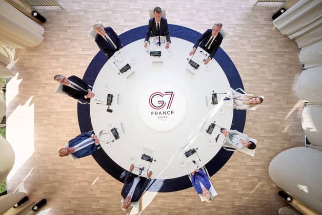 (From left to right) German Chancellor Friedrich Merz, British Prime Minister Keir Starmer, U.S. President Donald Trump, European Council President Antonio Costa, French President Emmanuel Macron, Canadian Prime Minister Mark Carney, Italian Prime Minister Giorgia Meloni, and European Commission President Ursula von der Leyen attend a working dinner with G7 leaders during the summit in Evian, eastern France, on Monday, June 15, 2026. The G7 Summit, scheduled from June 15 to 17 in Evian-les-Bains near the Swiss border, brings together heads of state along with the EU foreign policy chief and ministers from Brazil, Canada, the United Arab Emirates, and Turkey.  FRN2026061501 G7