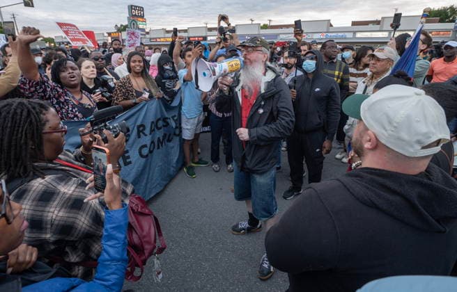 June 15, 2026, Montreal, Pq, Canada: A protester rallies others outside Montreal police station 39 in Montreal North during an anti police brutality protest on Monday June 15, 2026. Montreal Canada  - ZUMAc35_ 20260615_zaf_c35_132 Copyright: xPeterxMccabex