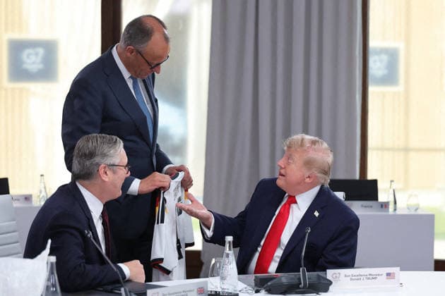 G7 Summit - Merz Presents Trump With German Football Jersey Germany s Chancellor Friedrich Merz presents US President Donald Trump with a German national football team jersey with the number 47 on it as British Prime Minister Keir Starmer looks on during a working session at the G7 summit in Evian-les-Bains, central-eastern France on June 16, 2026. Photo by Dominique Jacovides Pool ABACAPRESS.COM Evian France  Copyright: xJacovidesxDominique Pool ABACAx