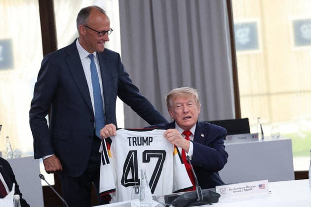 G7 Summit - Merz Presents Trump With German Football Jersey Germany s Chancellor Friedrich Merz presents US President Donald Trump with a German national football team jersey with the number 47 on it as British Prime Minister Keir Starmer looks on during a working session at the G7 summit in Evian-les-Bains, central-eastern France on June 16, 2026. Photo by Dominique Jacovides Pool ABACAPRESS.COM Evian France  Copyright: xJacovidesxDominique Pool ABACAx