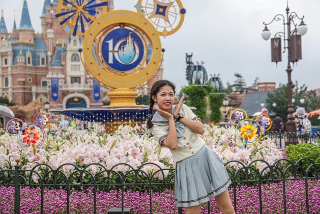 SHANGHAI, CHINA - JUNE 16: Tourists pose for photos with a floral display themed for the 10th anniversary on June 16, 2026 in Shanghai, China. Shanghai Disney Resort has received over 100 million visits since its opening.  Copyright: xVCGx 111648625138