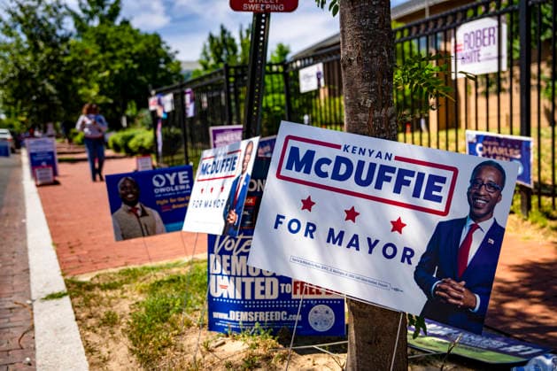 Signs for Kenyan Mcduffie, a candidate for DC Mayor, is seen outside Sherwood Recreation Center as people vote in Washington DC s 2026 primary elections on Tuesday, June 16, 2026. The two front-runners to succeed current DC Mayor Muriel Bowser are Kenyan McDuffie, a moderate with support from many of Bowser s cabinet, and Janeese Lewis George, democratic socialist who built her campaign around organized labor.  WAP20260616304 BONNIExCASH