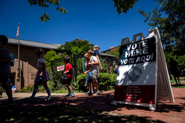 Children walk by Sherwood Recreation Center while it serves as a polling place for Washington DC s 2026 primary elections on Tuesday, June 16, 2026.The two front-runners to succeed current DC Mayor Muriel Bowser are Kenyan McDuffie, a moderate with support from many of Bowser s cabinet, and Janeese Lewis George, democratic socialist who built her campaign around organized labor.  WAP20260616309 BONNIExCASH
