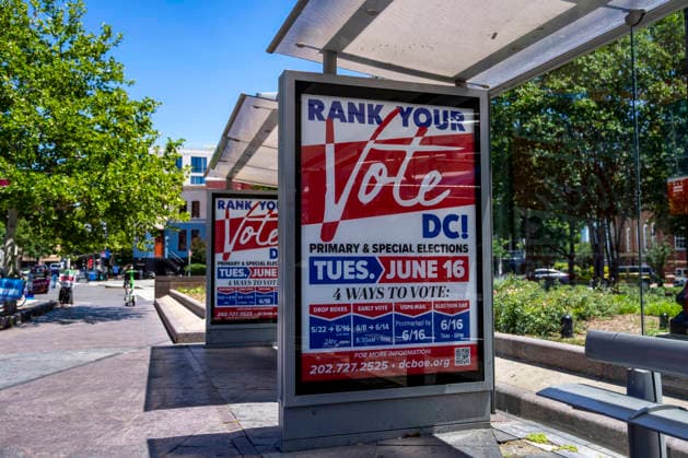 A bus stop advertisement for DC s primary elections are seen on Election Day on Tuesday, June 16, 2026. The two front-runners to succeed current DC Mayor Muriel Bowser are Kenyan McDuffie, a moderate with support from many of Bowser s cabinet, and Janeese Lewis George, democratic socialist who built her campaign around organized labor.  WAP20260616331 BONNIExCASH