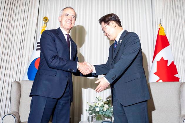 June 16, 2026, Evian-Les-Bains, France: Canadian Prime Minister Mark Carney, left, and Lee Jae Myung, president of South Korea, are illuminated by a photographeröÄÃ s flash, while meeting at the G7 summit in Evian-les-Bains, France, on Tuesday, June 16, 2026. Evian-Les-Bains France  - ZUMAc35_ 20260616_zaf_c35_076 Copyright: xChristopherxKatsarovx