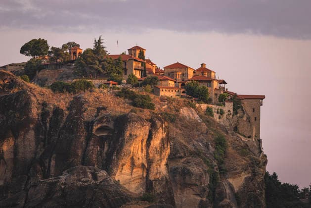 Creative Highlights World #2 Meteora monastery perched on a rock cliff at sunset Kalabaka, Thessaly, Greece CR_NEAN26061531-2053564-01
