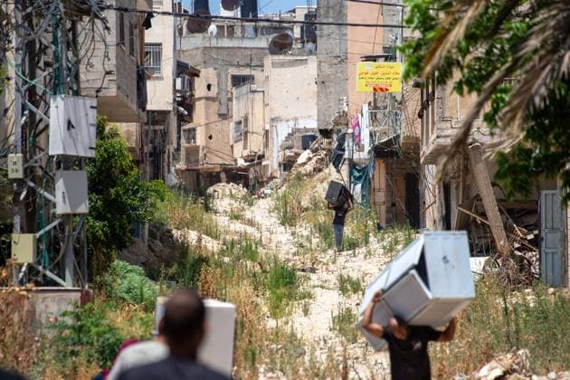 Displaced Families Granted Brief Access to Retrieve Belongings from Tulkarm Camp TULKARM REFUGEE CAMP, WEST BANK JUNE 17, 2026: Palestinian residents carry personal belongings after Israeli authorities allowed 45 families to enter Tulkarm refugee camp for a limited period to retrieve items from their homes. The visit comes amid the ongoing Israeli military operation in Tulkarm and Nur Shams refugee camps, which has displaced large numbers of residents and caused significant damage to homes and infrastructure. Photo by Mojahid Nawahda JNA Press. (Photo by Mojahid Nwahda JNA Press via Nexpher Images) TULKARM